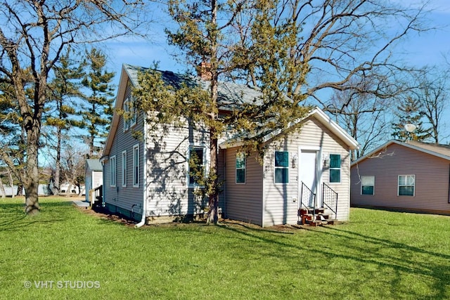 exterior space featuring entry steps and a lawn