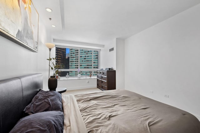 bedroom featuring visible vents, a city view, and recessed lighting