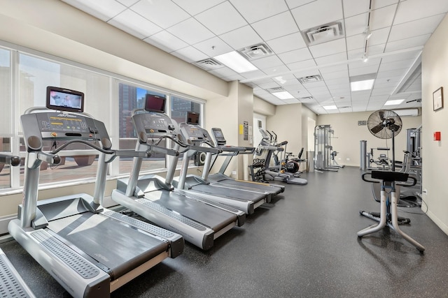 gym featuring baseboards, visible vents, and a drop ceiling