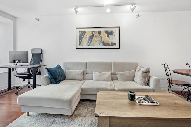 living room with baseboards and wood finished floors