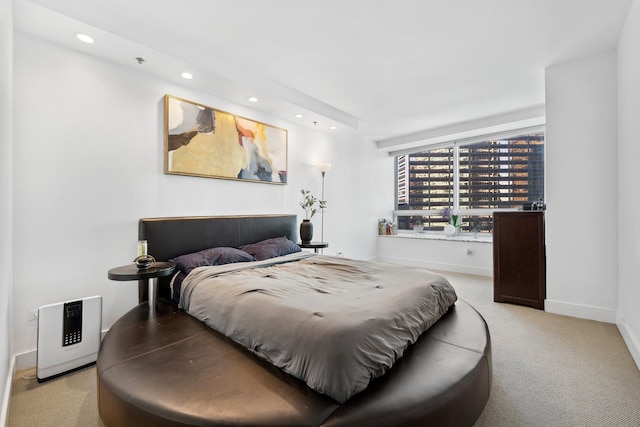 bedroom with recessed lighting, light carpet, and baseboards