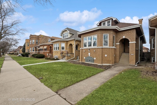 view of front of property featuring a shingled roof, a front yard, a residential view, and brick siding