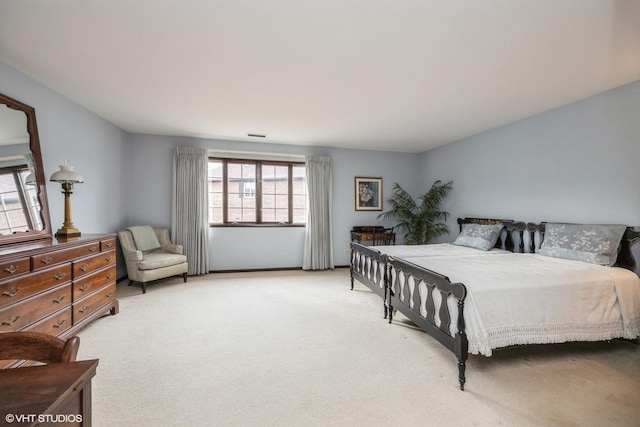 bedroom featuring light carpet