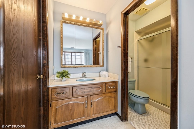 full bathroom featuring toilet, a stall shower, visible vents, and vanity