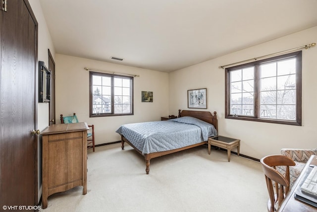 bedroom featuring light carpet, baseboards, and visible vents