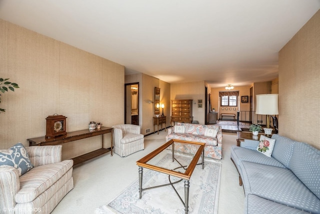 carpeted living area with wallpapered walls