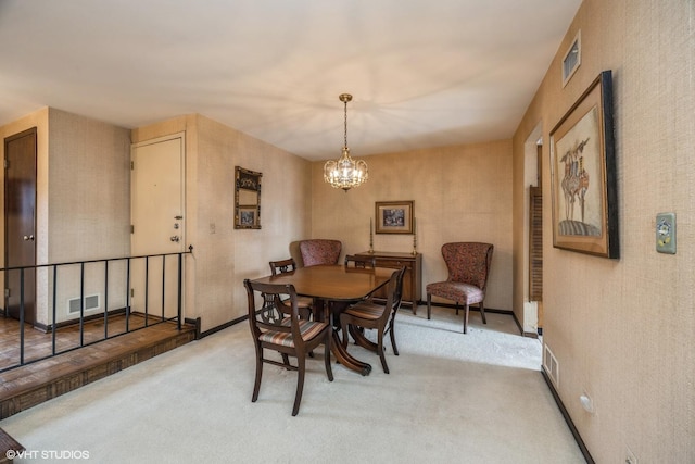 carpeted dining room with visible vents and a notable chandelier