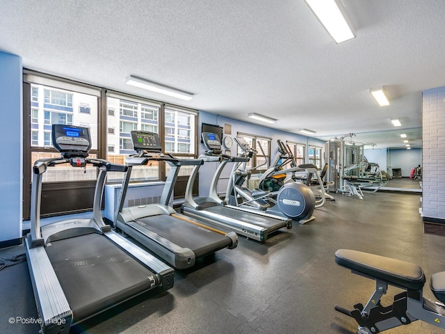 gym featuring a textured ceiling