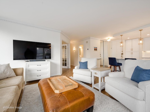 living area with wood finished floors and crown molding