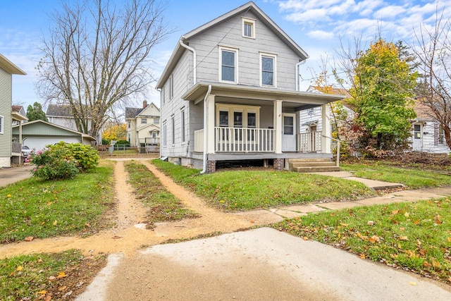 traditional style home featuring covered porch and a front lawn