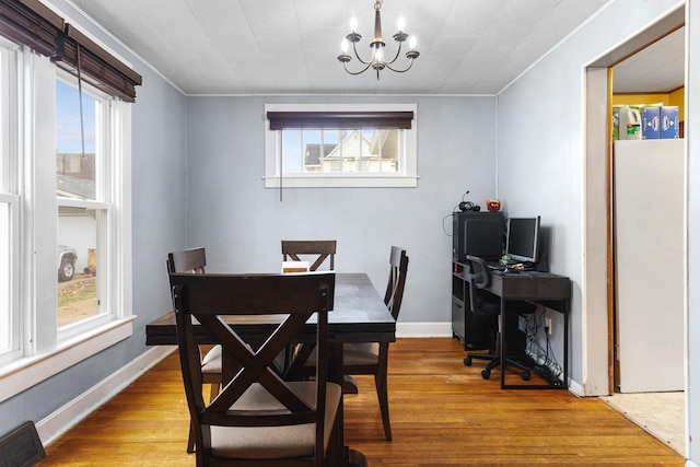 dining room with visible vents, light wood finished floors, a chandelier, and a wealth of natural light