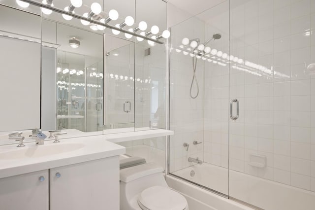 bathroom featuring shower / bath combination with glass door, vanity, and toilet