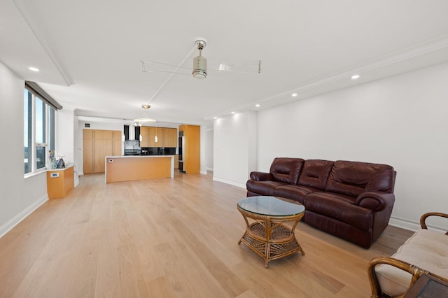 living area featuring recessed lighting, ceiling fan, light wood-style flooring, and baseboards