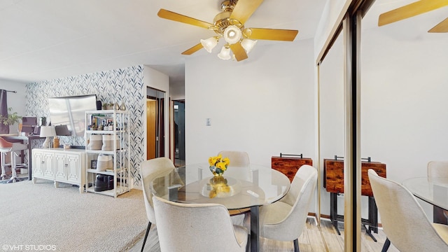 carpeted dining space with wallpapered walls