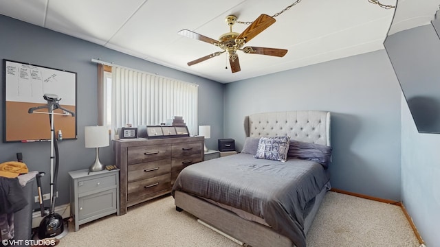 bedroom featuring ceiling fan, baseboards, and light colored carpet