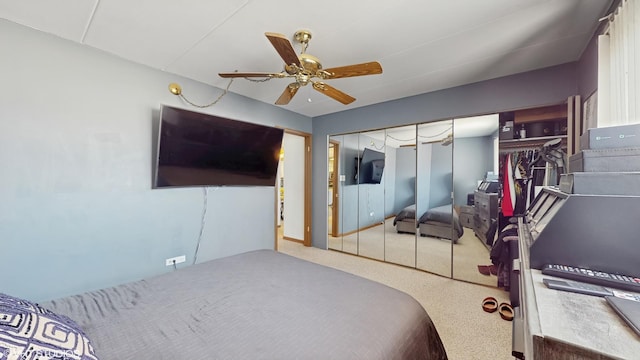 carpeted bedroom featuring ceiling fan and a closet