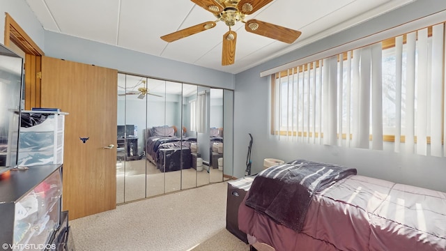 bedroom with a ceiling fan and a closet