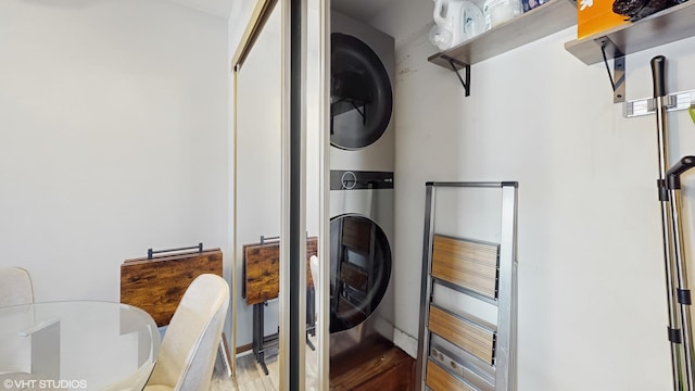 laundry room featuring laundry area and stacked washer and clothes dryer