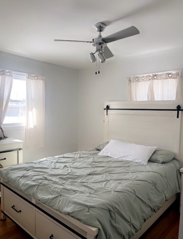 bedroom featuring dark wood-style flooring and a ceiling fan