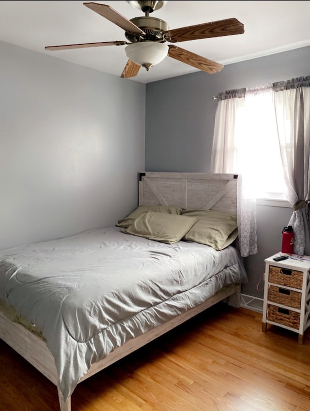 bedroom with ceiling fan and wood finished floors