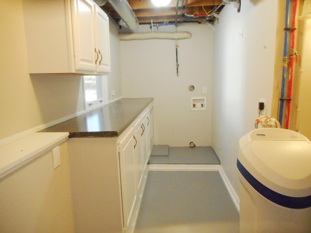 washroom featuring washer hookup and cabinet space