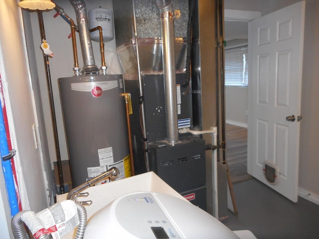 utility room featuring water heater