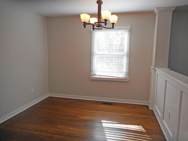 unfurnished dining area featuring visible vents, baseboards, a chandelier, and dark wood-style flooring