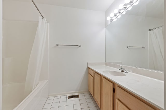 full bathroom with vanity, visible vents, baseboards, shower / bath combo, and tile patterned floors