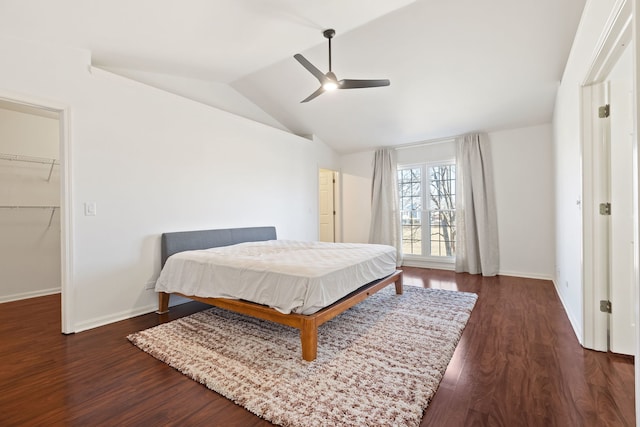 bedroom featuring lofted ceiling, wood finished floors, and baseboards