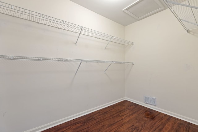 spacious closet with visible vents, attic access, and wood finished floors