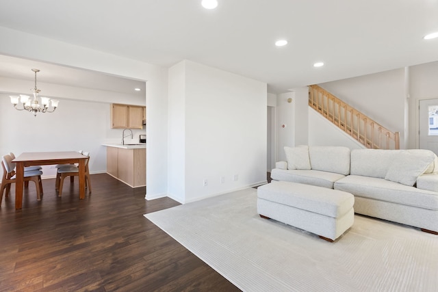 living area featuring recessed lighting, stairway, a chandelier, and dark wood-style flooring