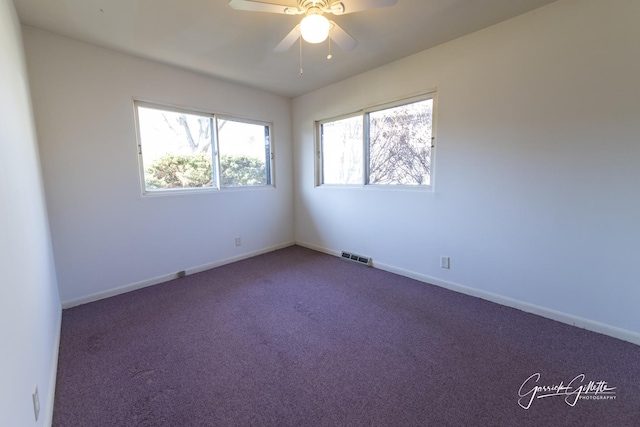 spare room featuring a ceiling fan, carpet, visible vents, and baseboards