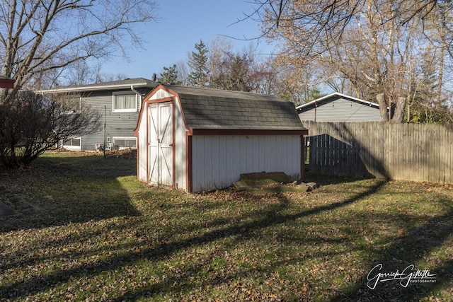 view of shed featuring fence