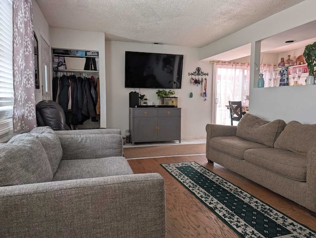 living area featuring a textured ceiling and wood finished floors