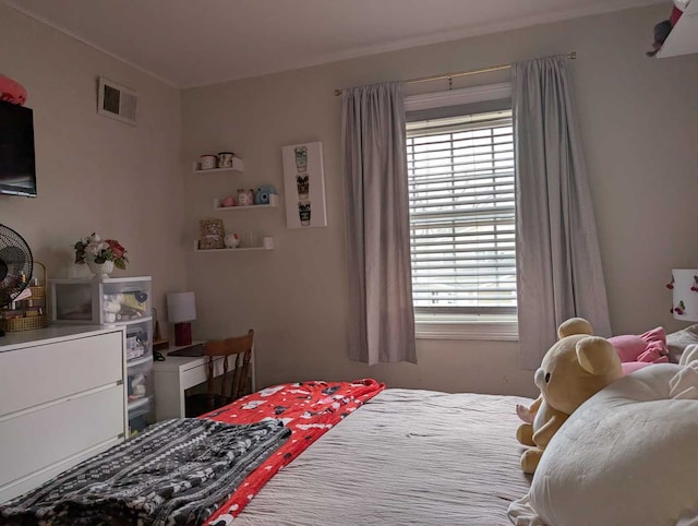 bedroom featuring multiple windows and visible vents