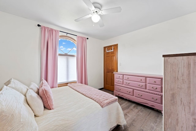 bedroom with a ceiling fan and wood finished floors