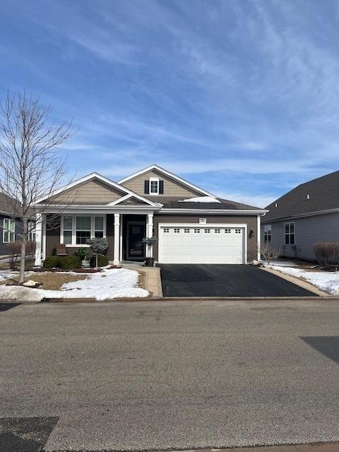 view of front of home with a garage and aphalt driveway