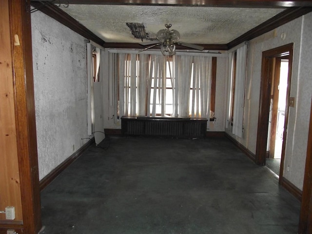 unfurnished room featuring a ceiling fan, radiator, a textured ceiling, and baseboards