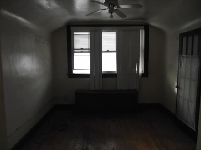 additional living space with lofted ceiling, ceiling fan, and wood finished floors