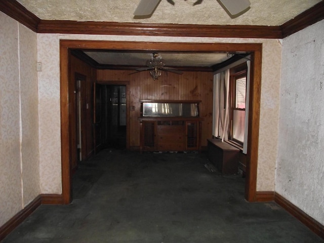 hall with wallpapered walls, dark carpet, and crown molding