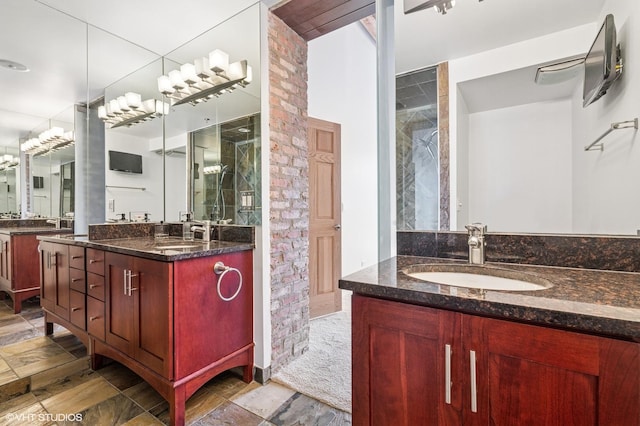 full bathroom with a shower stall, two vanities, and a sink