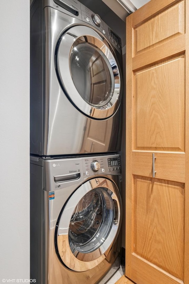 clothes washing area featuring laundry area and stacked washer / drying machine