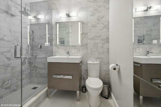 bathroom with vanity, tile patterned floors, toilet, and a stall shower