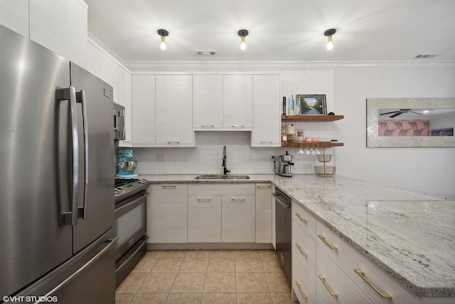 kitchen featuring ornamental molding, tasteful backsplash, appliances with stainless steel finishes, and a sink