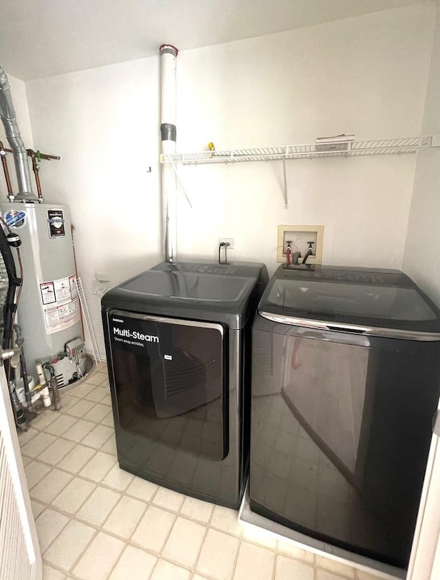 laundry room with water heater, laundry area, and washer and dryer