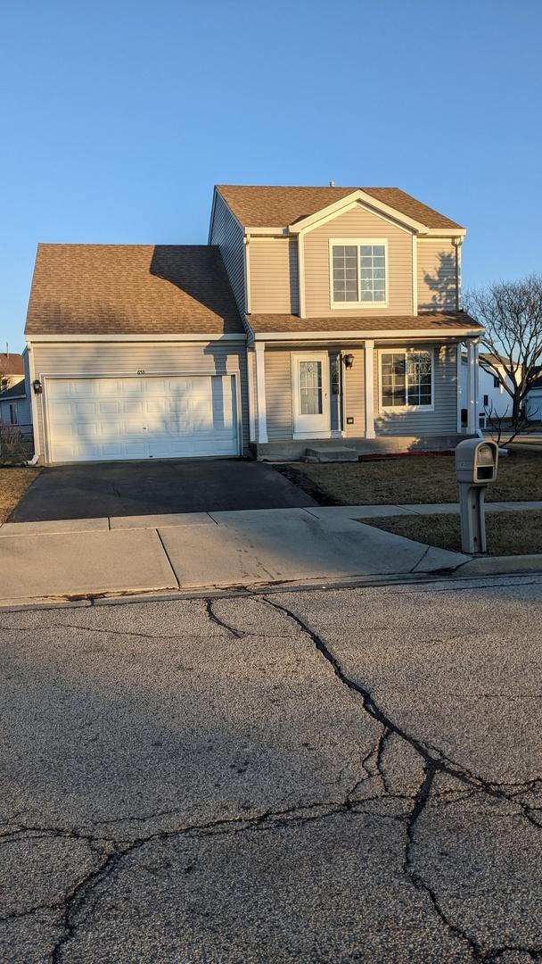 traditional home with aphalt driveway and an attached garage