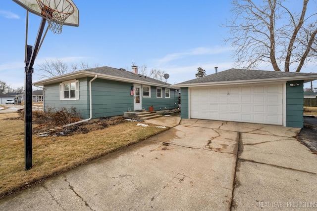 single story home featuring a detached garage and a chimney