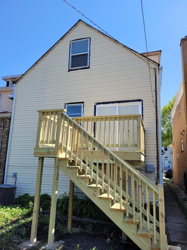 back of property with stairway and cooling unit