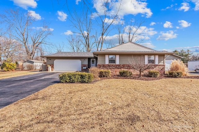 ranch-style house with a front yard, brick siding, driveway, and an attached garage