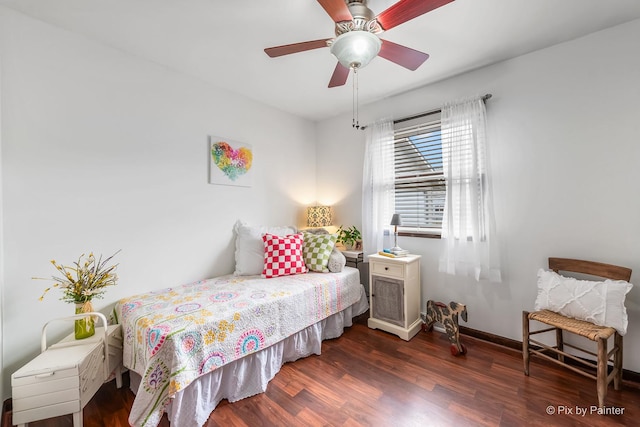 bedroom featuring a ceiling fan, baseboards, and wood finished floors